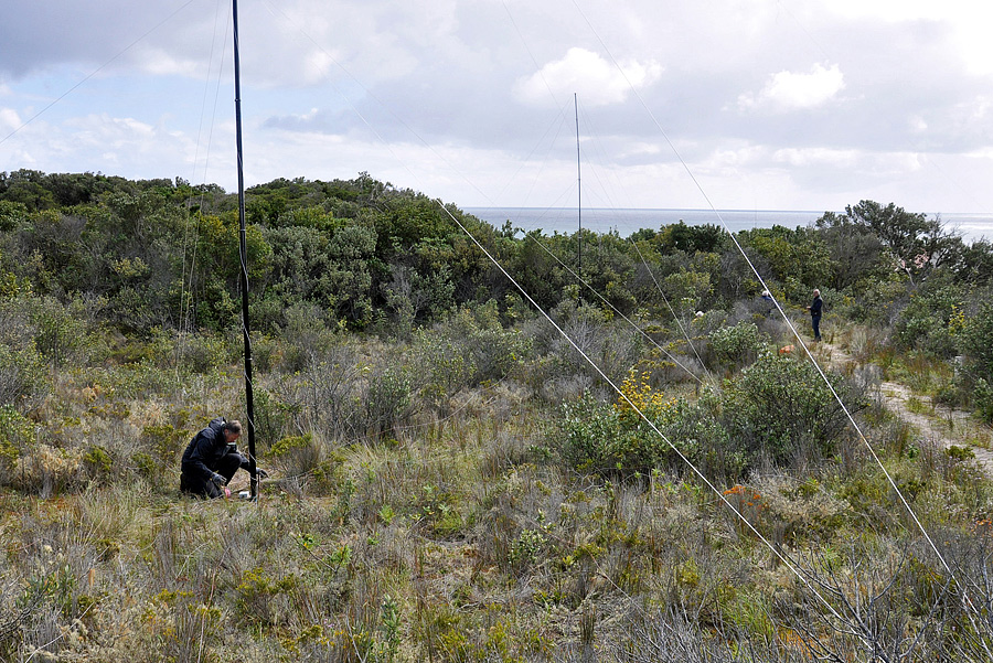 Chris G3SVL at the base of the 160m antenna at ZL7G with a receive antenna in the back-ground.